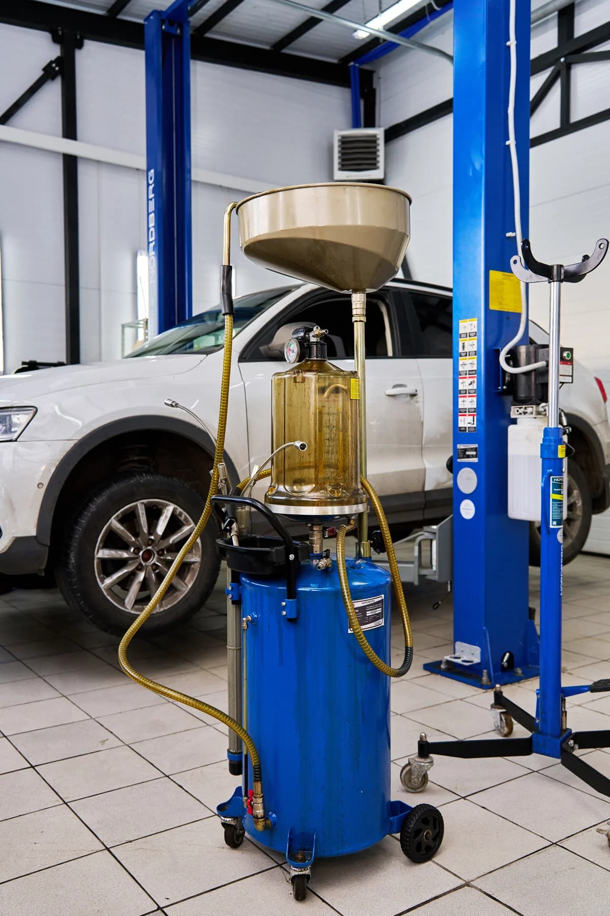 Установка для сбора масла Nordberg 2379B — пневматическая, 65 л, синяя, с осмотровой колбой